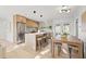 Bright open kitchen with stainless steel appliances, a central island, and dining area for a modern, inviting space at 5900 6Th S Way, St Petersburg, FL 33705