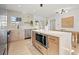 Open-concept kitchen featuring a central island, stainless steel appliances, and a dining area for easy entertaining at 5900 6Th S Way, St Petersburg, FL 33705