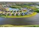 Aerial view of lakefront homes showcasing lush landscaping and neighborhood layout at 5902 106Th E Ter, Parrish, FL 34219