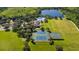 Aerial view of community featuring a swimming pool, tennis courts, and verdant landscaping by a lake at 5902 106Th E Ter, Parrish, FL 34219