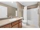 Well-lit bathroom featuring a single sink vanity with wood cabinets, a toilet, and a shower with a white curtain at 5902 106Th E Ter, Parrish, FL 34219