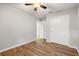 A roomy bedroom with wood-look flooring, fresh paint, a ceiling fan and closet, offering a blank canvas at 5902 106Th E Ter, Parrish, FL 34219