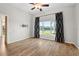 Large bedroom with wood floors, ceiling fan, and tv hookups overlooking lake at 5902 106Th E Ter, Parrish, FL 34219