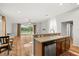 Open kitchen with granite countertops, stainless steel appliances, and breakfast bar overlooking the living area at 5902 106Th E Ter, Parrish, FL 34219