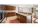 Well-lit kitchen featuring wood cabinets, tile floors, and an open floor plan at 5902 106Th E Ter, Parrish, FL 34219
