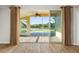 Screened lanai with brick flooring overlooking lake and tropical landscaping at 5902 106Th E Ter, Parrish, FL 34219