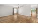 Open living room with hardwood floors, neutral paint, and backyard access at 5902 106Th E Ter, Parrish, FL 34219