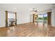 Spacious living room with wood floors, ceiling fan, and sliding glass doors to lanai at 5902 106Th E Ter, Parrish, FL 34219