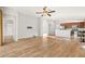 Open concept living area with wood floors, doors to outside and kitchen access at 5902 106Th E Ter, Parrish, FL 34219