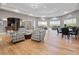 Bright lounge with multiple seating areas, wet bar, and lots of natural light at 5902 106Th E Ter, Parrish, FL 34219