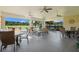 Relaxing outdoor patio with seating, ceiling fans, and lovely views of the lawn at 5902 106Th E Ter, Parrish, FL 34219
