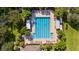 Overhead view of a sparkling swimming pool surrounded by ample lounging space and palm trees at 5902 106Th E Ter, Parrish, FL 34219