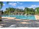 Beautiful community pool area with ample seating, a pergola, and sparkling blue water at 5902 106Th E Ter, Parrish, FL 34219