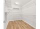 Spacious walk-in closet with wooden floors, white walls, wire shelving, and ample storage space at 5902 106Th E Ter, Parrish, FL 34219