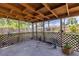 Covered patio area perfect for outdoor relaxation, with wood framing and a view of the yard at 5916 Gulfport S Blvd, Gulfport, FL 33707