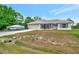 Single-story home featuring an attached two-car garage and a boat on the driveway at 6104 Plamendon Ave, North Port, FL 34291