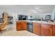 Open concept kitchen with wood cabinets, stainless steel appliances, and tile flooring at 6104 Plamendon Ave, North Port, FL 34291