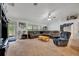 Bright living room with vaulted ceilings, a plush sectional sofa, and natural light at 6104 Plamendon Ave, North Port, FL 34291