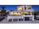 Stunning exterior view with a walk out pool and deck, and beachfront views at 6381 Gulf Of Mexico Dr, Longboat Key, FL 34228