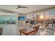 Inviting living room with tile floors, comfortable seating, and walls of sliding glass doors with water views at 6381 Gulf Of Mexico Dr, Longboat Key, FL 34228