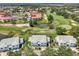 An aerial view of charming townhomes with a golf course, a pond and lush trees at 6546 Fairway Gardens Dr # 6546, Bradenton, FL 34203