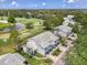 An aerial view features the townhomes near a pond, a golf course, and tall palms at 6546 Fairway Gardens Dr # 6546, Bradenton, FL 34203