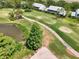 Stunning aerial view of condos nestled on a golf course, showcasing a tranquil pond and lush green fairways at 6546 Fairway Gardens Dr # 6546, Bradenton, FL 34203