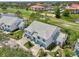 Aerial view showcases the lush landscaping, the pond, and the surrounding golf course at 6546 Fairway Gardens Dr # 6546, Bradenton, FL 34203