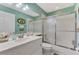 Bathroom features a white vanity, tub with shower, and soft blue-green walls, creating a tranquil retreat at 6546 Fairway Gardens Dr # 6546, Bradenton, FL 34203