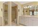Well-lit bathroom features a double sink vanity, ample storage, and a separate toilet and shower area at 6546 Fairway Gardens Dr # 6546, Bradenton, FL 34203