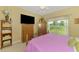 A comfortably designed bedroom features a ceiling fan, backyard views and lots of storage at 6546 Fairway Gardens Dr # 6546, Bradenton, FL 34203