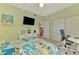 Comfortable bedroom with TV and a desk workspace features neutral decor, and a relaxing atmosphere at 6546 Fairway Gardens Dr # 6546, Bradenton, FL 34203