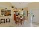 The dining room boasts a light fixture, a view of the backyard, and flows into the kitchen at 6546 Fairway Gardens Dr # 6546, Bradenton, FL 34203