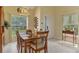Bright dining area, adjacent to the front door, featuring natural light and an inviting table setting at 6546 Fairway Gardens Dr # 6546, Bradenton, FL 34203