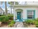 Inviting entryway with teal trim, a decorative door, and lush landscaping at 6546 Fairway Gardens Dr # 6546, Bradenton, FL 34203