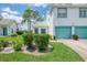 Charming two-story home with a two car garage, lush lawn and teal trim accents at 6546 Fairway Gardens Dr # 6546, Bradenton, FL 34203