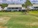 Building exterior showing a large lawn and trees at 6546 Fairway Gardens Dr # 6546, Bradenton, FL 34203