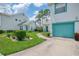 Charming townhome with lush landscaping, teal accents and a quaint walkway at 6546 Fairway Gardens Dr # 6546, Bradenton, FL 34203