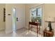 Bright foyer features tile floors, a side table, and a decorative rug for a warm welcome at 6546 Fairway Gardens Dr # 6546, Bradenton, FL 34203