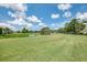 Scenic view of golf course featuring a pond, lush green grass, and clear blue skies at 6546 Fairway Gardens Dr # 6546, Bradenton, FL 34203