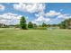 Beautiful golf course scene with a serene pond, lush greenery, and a residential building in the distance at 6546 Fairway Gardens Dr # 6546, Bradenton, FL 34203
