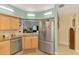 Spacious kitchen with stainless steel appliances, granite countertops, and wood-look tile flooring at 6546 Fairway Gardens Dr # 6546, Bradenton, FL 34203