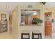 Eat-in kitchen features granite countertops, light wood cabinets, and two bar stools for casual dining at 6546 Fairway Gardens Dr # 6546, Bradenton, FL 34203