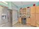 Spacious kitchen with stainless steel refrigerator, wine cooler, granite countertops, and ample storage at 6546 Fairway Gardens Dr # 6546, Bradenton, FL 34203