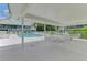 Inviting pool area with tables, chairs, and lounge chairs under the shade of a covered patio at 6546 Fairway Gardens Dr # 6546, Bradenton, FL 34203