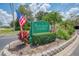Plantation Gardens at Tara community sign with an American flag and manicured landscaping at 6546 Fairway Gardens Dr # 6546, Bradenton, FL 34203
