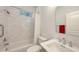 Bright bathroom features a shower over tub with marble style walls, and a single sink vanity at 6721 Oak Manor Dr, Lakewood Ranch, FL 34202