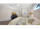 Relaxing bedroom features modern furniture, wood floors, and natural lighting at 6721 Oak Manor Dr, Lakewood Ranch, FL 34202