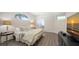 Comfortable bedroom featuring a decorative window, wood floors, and a calming color palette at 6721 Oak Manor Dr, Lakewood Ranch, FL 34202