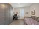 This room has wood-look floors, large closet, a desk, and a bed with colorful bedding at 6721 Oak Manor Dr, Lakewood Ranch, FL 34202